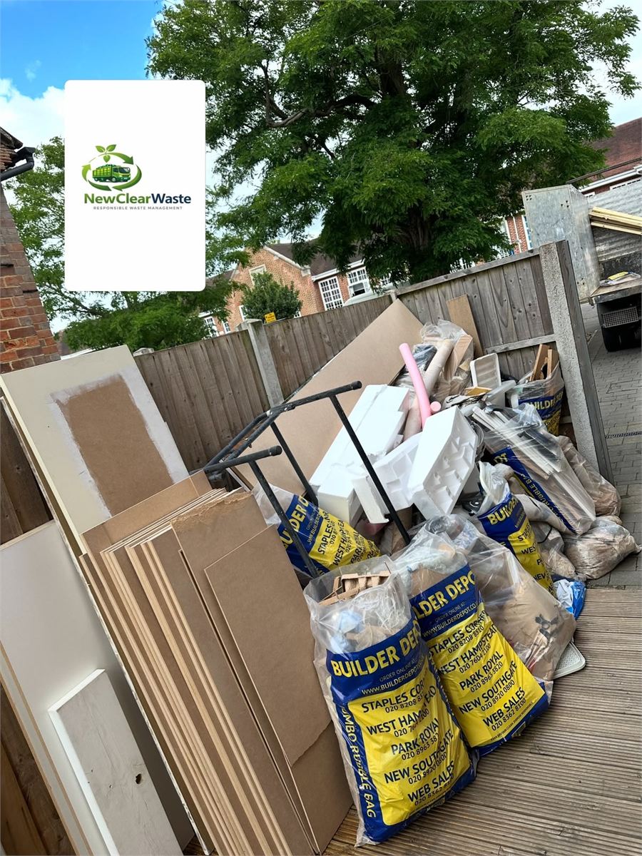 Builders bags, boards and packaging covering a timber deck before collection