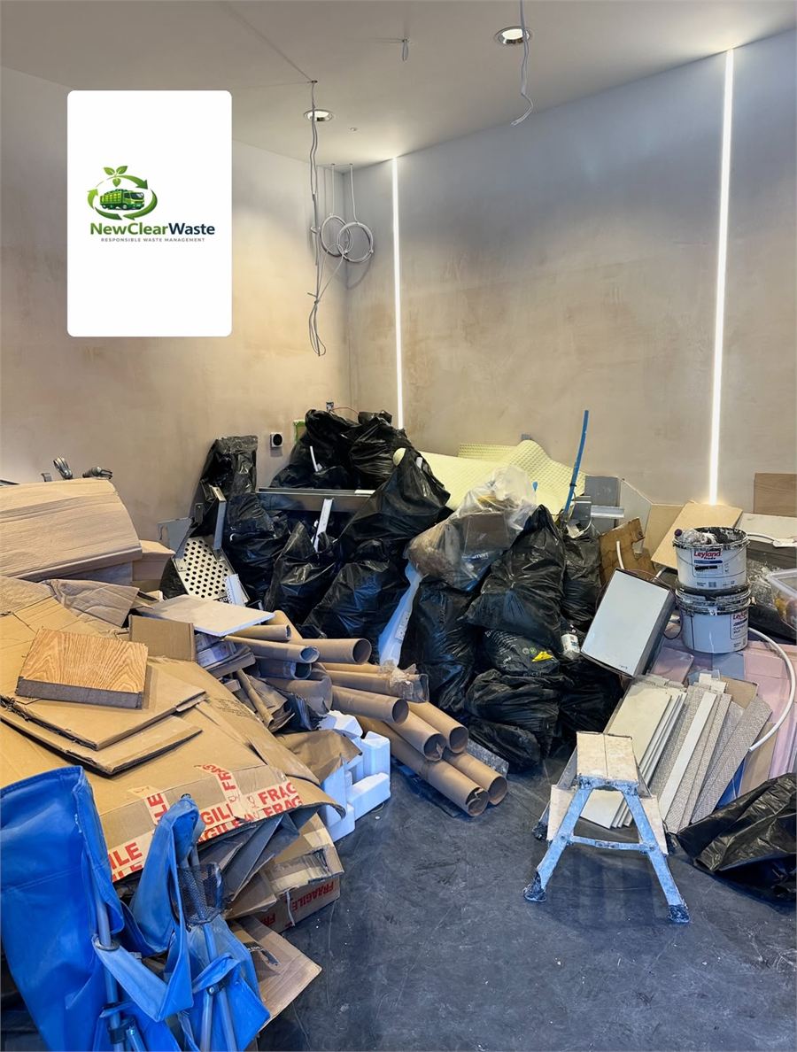 Large interior room filled with renovation waste before collection